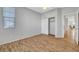 Bedroom featuring wood-look floors, a ceiling fan and a closet with sliding doors at 5919 Pavilion Lakes Ave, Las Vegas, NV 89122
