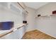 Walk-in closet features shelving with wood supports and wood-look floors at 5919 Pavilion Lakes Ave, Las Vegas, NV 89122