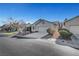 Street view of a well-maintained single-story house featuring desert landscaping and a two-car garage at 5919 Pavilion Lakes Ave, Las Vegas, NV 89122