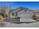Charming single-story home boasts a two-car garage, low maintenance landscaping, and lots of curb appeal at 5919 Pavilion Lakes Ave, Las Vegas, NV 89122