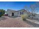 A tan single-story house showing low maintenance landscaping and a covered front entryway at 5919 Pavilion Lakes Ave, Las Vegas, NV 89122