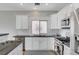 Kitchen featuring stainless appliances, gray countertops, white subway tile backsplash, and white cabinetry at 5919 Pavilion Lakes Ave, Las Vegas, NV 89122