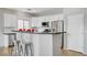 Modern kitchen with breakfast bar, stainless steel appliances, and white cabinets at 5919 Pavilion Lakes Ave, Las Vegas, NV 89122