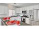 Bright kitchen with white cabinets, stainless steel appliances, subway tile backsplash and dark countertops at 5919 Pavilion Lakes Ave, Las Vegas, NV 89122
