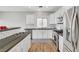 Kitchen with white cabinets, subway tile backsplash, stainless steel appliances, and wood flooring at 5919 Pavilion Lakes Ave, Las Vegas, NV 89122