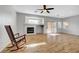 Open living room featuring a fireplace, ceiling fan and wood-style flooring at 5919 Pavilion Lakes Ave, Las Vegas, NV 89122