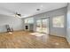 Bright living room with hardwood floors, fireplace, and sliding door to backyard at 5919 Pavilion Lakes Ave, Las Vegas, NV 89122