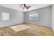 Spacious main bedroom with wood flooring, ceiling fan, and lots of natural light at 5919 Pavilion Lakes Ave, Las Vegas, NV 89122