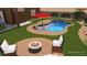 Rendered image of a backyard with a beautiful pool, lounge chairs, and a cozy fire pit at 5919 Pavilion Lakes Ave, Las Vegas, NV 89122