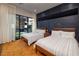 Sunlit bedroom with two twin beds and floor-to-ceiling sliding glass door, offering a private outdoor view at 609 Sleeping Dragon Dr, Henderson, NV 89012