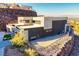 Modern hillside home featuring a flat roof, two-car garage, and xeriscaped backyard at 609 Sleeping Dragon Dr, Henderson, NV 89012