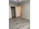 Well-lit bedroom with mirrored closet doors and wood-look floors at 6255 Peneplain Ave, Las Vegas, NV 89139