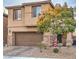 Two-story house with brown garage door and stone accents at 6735 Pleasant Flower St, Las Vegas, NV 89149