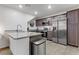 Modern kitchen with stainless steel appliances and gray countertops at 6815 Sage Gold Ct, North Las Vegas, NV 89086