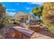 Spacious backyard with covered patio, fire pit, and stone pathway at 7152 Royal Melbourne Dr, Las Vegas, NV 89131