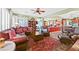 Bright living room featuring leather sofas and a red area rug at 7152 Royal Melbourne Dr, Las Vegas, NV 89131