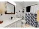 Clean bathroom with white vanity and floral shower curtain at 929 Rockview Dr # 202, Las Vegas, NV 89128