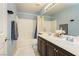 Clean bathroom with double sinks and bathtub shower combo at 9904 Garamound Ave, Las Vegas, NV 89117