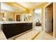 Luxurious bathroom with double vanity and view into bedroom at 9904 Garamound Ave, Las Vegas, NV 89117