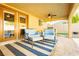 Covered patio with comfortable seating and ceiling fan at 9904 Garamound Ave, Las Vegas, NV 89117