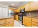 Modern kitchen with stainless steel appliances and wood cabinets at 9904 Garamound Ave, Las Vegas, NV 89117