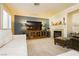 Spacious living room with sectional sofa, fireplace, and large TV at 9904 Garamound Ave, Las Vegas, NV 89117