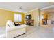 Living room with tiled floors, white sofas, and yellow walls at 9904 Garamound Ave, Las Vegas, NV 89117