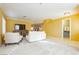 Living room with tiled floors, white sofas, and yellow walls at 9904 Garamound Ave, Las Vegas, NV 89117