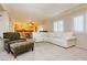 Bright living room with large sectional sofa and view of kitchen at 9904 Garamound Ave, Las Vegas, NV 89117