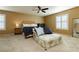 Bright main bedroom with king-size bed and window seating at 9904 Garamound Ave, Las Vegas, NV 89117