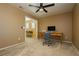 Bright home office with built-in desk and ceiling fan at 9904 Garamound Ave, Las Vegas, NV 89117