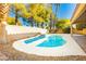 Relaxing kidney shaped pool with surrounding landscaping at 9904 Garamound Ave, Las Vegas, NV 89117