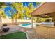 Large backyard pool with brick BBQ and patio area at 9904 Garamound Ave, Las Vegas, NV 89117