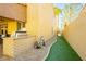 Landscaped side yard with built-in grill and artificial turf at 9904 Garamound Ave, Las Vegas, NV 89117