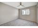 Bright bedroom featuring a ceiling fan and carpet flooring at 9967 Blue Rain St, Las Vegas, NV 89178