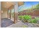 Landscaped backyard with brick patio and lush plants at 10375 Pescado Ln, Las Vegas, NV 89135