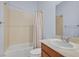 Clean bathroom with a shower/tub combo, vanity, and beige walls at 10375 Pescado Ln, Las Vegas, NV 89135