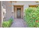 Front entry with brick walkway and lush green shrubs at 10375 Pescado Ln, Las Vegas, NV 89135