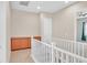 Upstairs hallway with built-in cabinets and white railing at 10375 Pescado Ln, Las Vegas, NV 89135