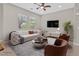 Living room with cream sofa and brown armchairs at 10375 Pescado Ln, Las Vegas, NV 89135