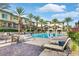 Community pool with lounge chairs and patio tables at 10375 Pescado Ln, Las Vegas, NV 89135