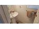 Small bathroom with pedestal sink and tan tile floor at 12064 Avery Meadows Ave, Las Vegas, NV 89138