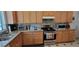 Spacious kitchen with wood cabinets and granite countertops at 12064 Avery Meadows Ave, Las Vegas, NV 89138