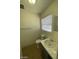 Clean bathroom with toilet, sink, and window at 1590 Mustang Dr, Henderson, NV 89002