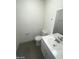 Updated bathroom with white vanity and grey floor at 1590 Mustang Dr, Henderson, NV 89002