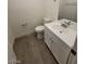 Updated bathroom with white vanity and grey floor at 1590 Mustang Dr, Henderson, NV 89002
