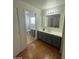 Main bathroom with double vanity and access to toilet at 1590 Mustang Dr, Henderson, NV 89002