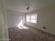 Spacious bedroom with neutral carpeting and ample sunlight at 1590 Mustang Dr, Henderson, NV 89002