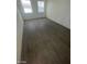 Bedroom with wood flooring and two windows at 1590 Mustang Dr, Henderson, NV 89002