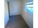 Simple bedroom with window, carpeted floors and door at 1590 Mustang Dr, Henderson, NV 89002